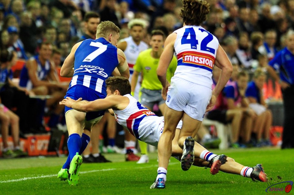 North Melbourne captain Jack Zeibell (7) evades the bulldogs tackle