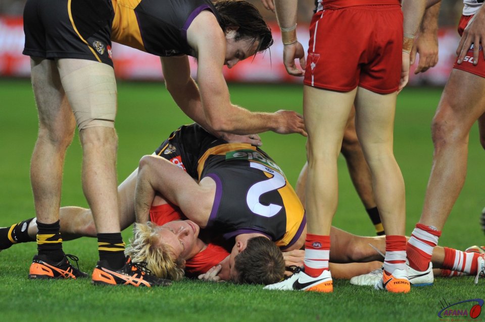 Isaac Heeney is crunched by Dylan Grimes