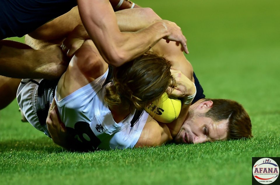 Tom Langdon wraps Cameron Polson up in a crunching tackle