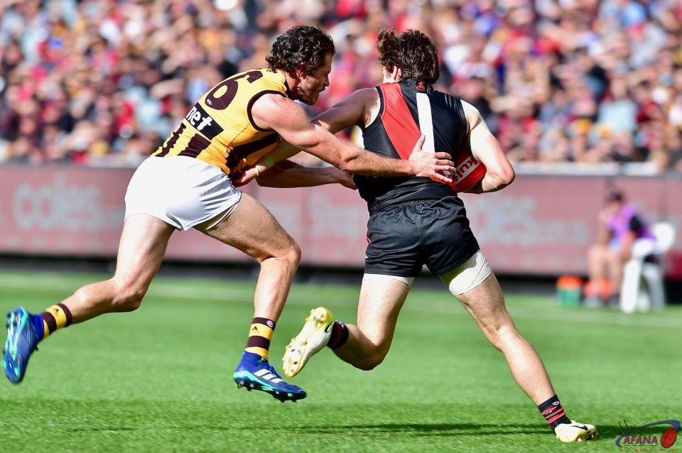Essendon rising start Andy McGrath attempts to fend off Isaac Smith